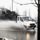 Pri zbirnem centru ob dežju poplavlja cesto